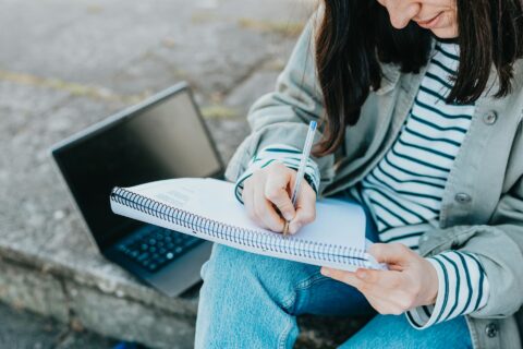 A woman writing in her notebook