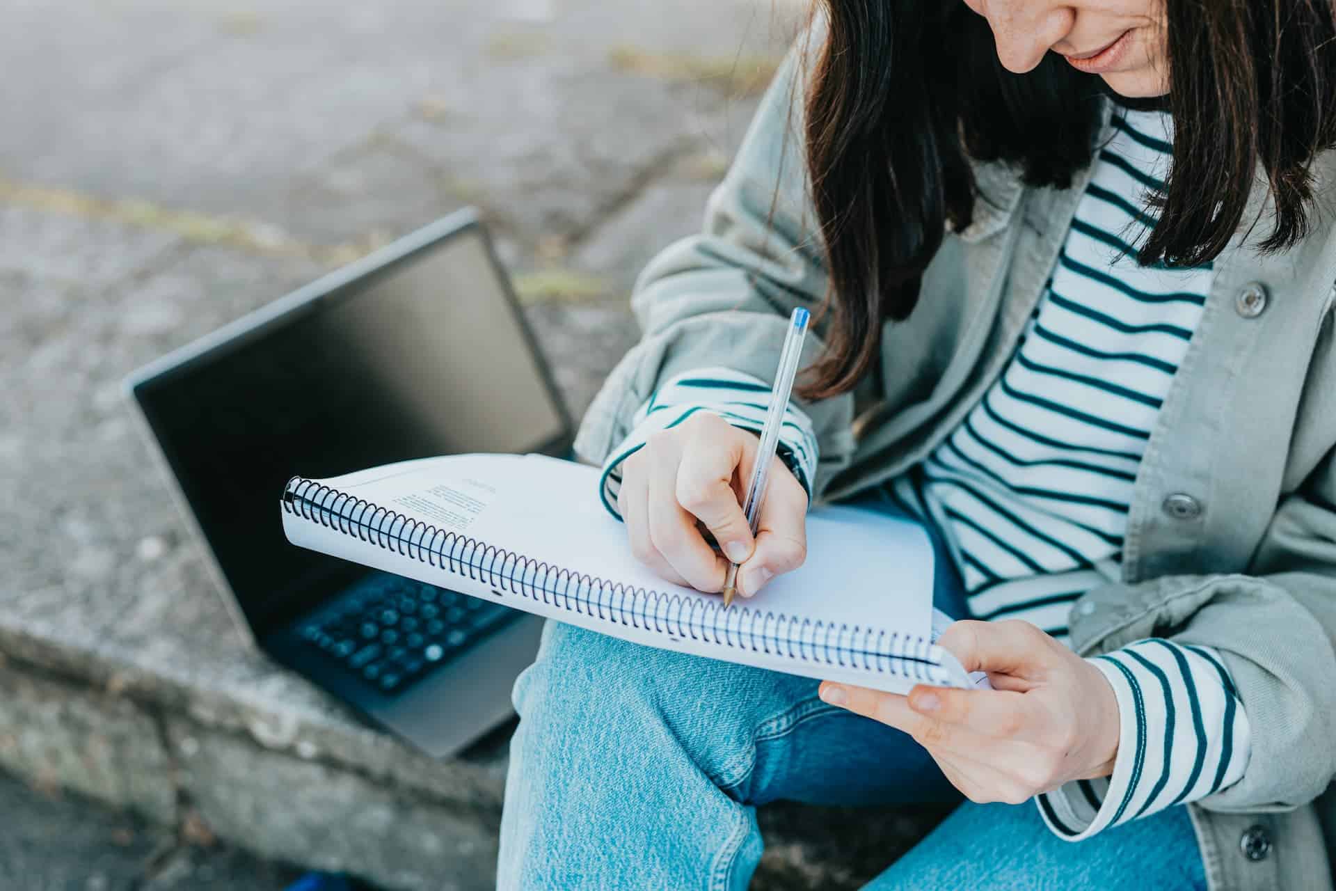 A woman writing in her notebook